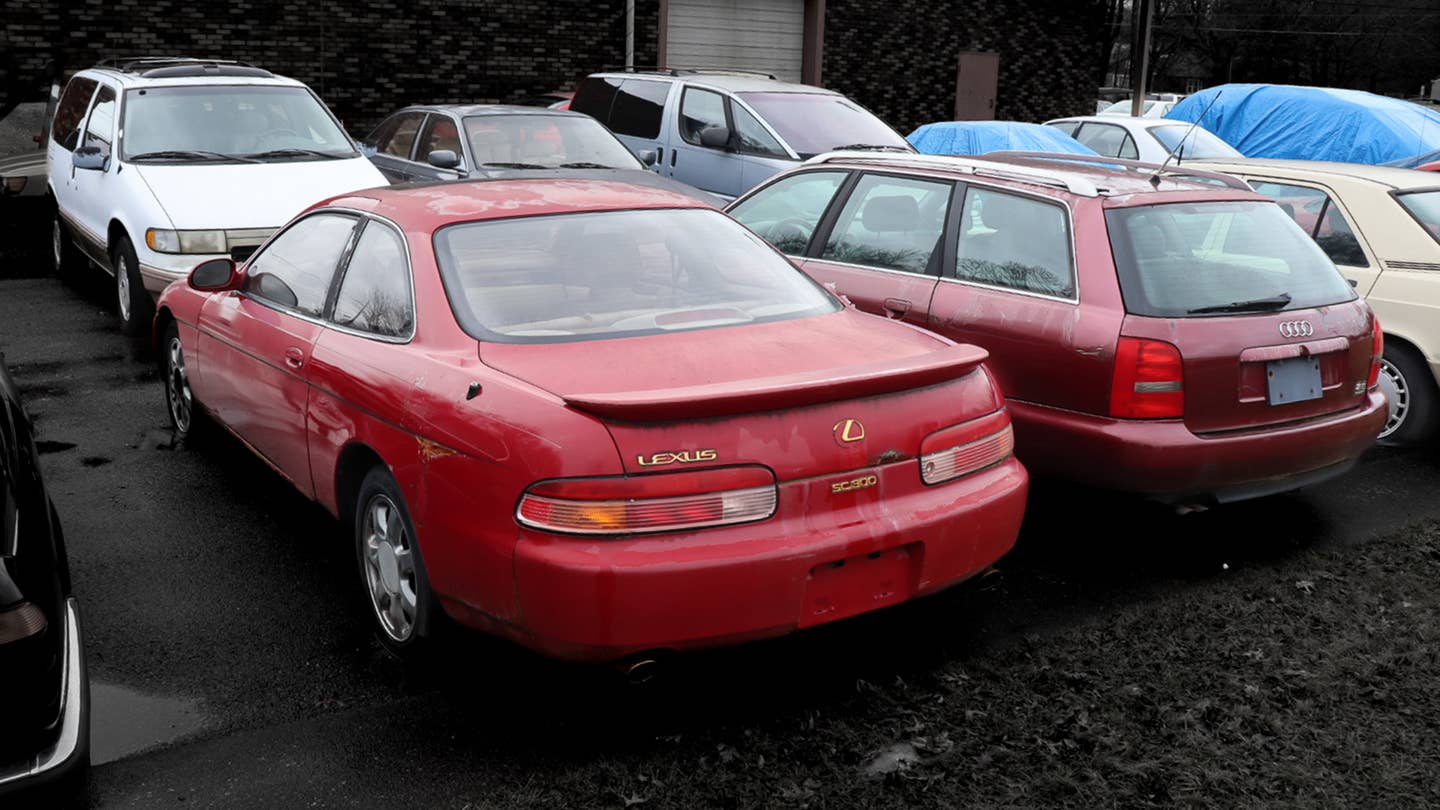 A used car parking lot with a Lexus and an Audi wagon.