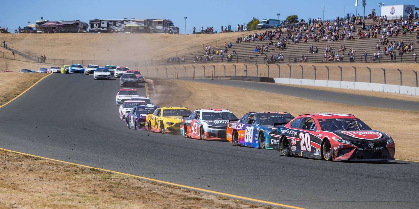 A line of cars led by Christopher Bell, driver of the #20 Joe Gibbs Racing Rheem/Smurfit Kappa Toyota, snakes by the grandstand during the NASCAR Cup Series Toyota/Save Mart 350 on June 6, 2021 at Sonoma Raceway in Sonoma, CA.