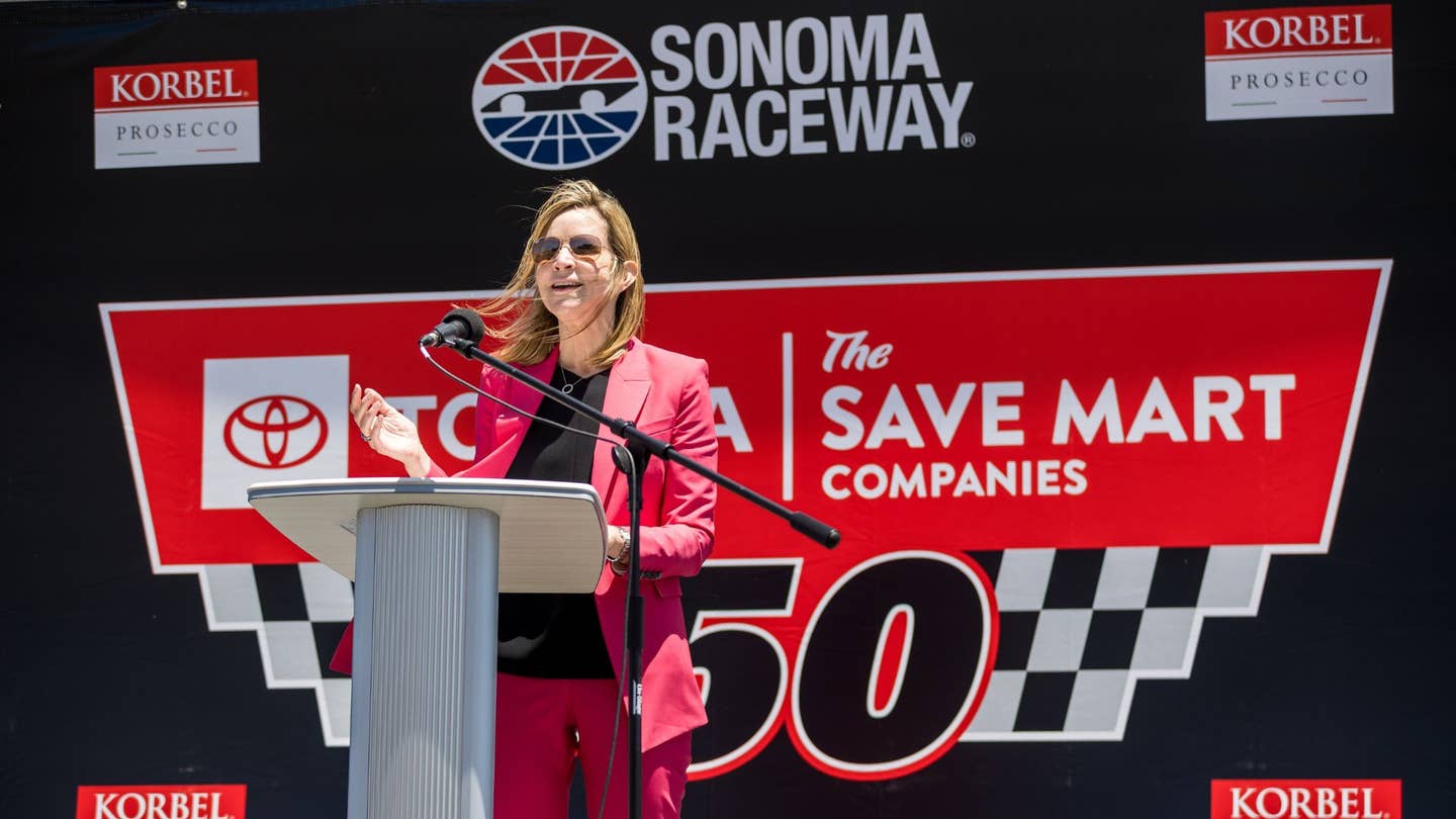 Woman wearing pink suit at Sonoma Raceway podium