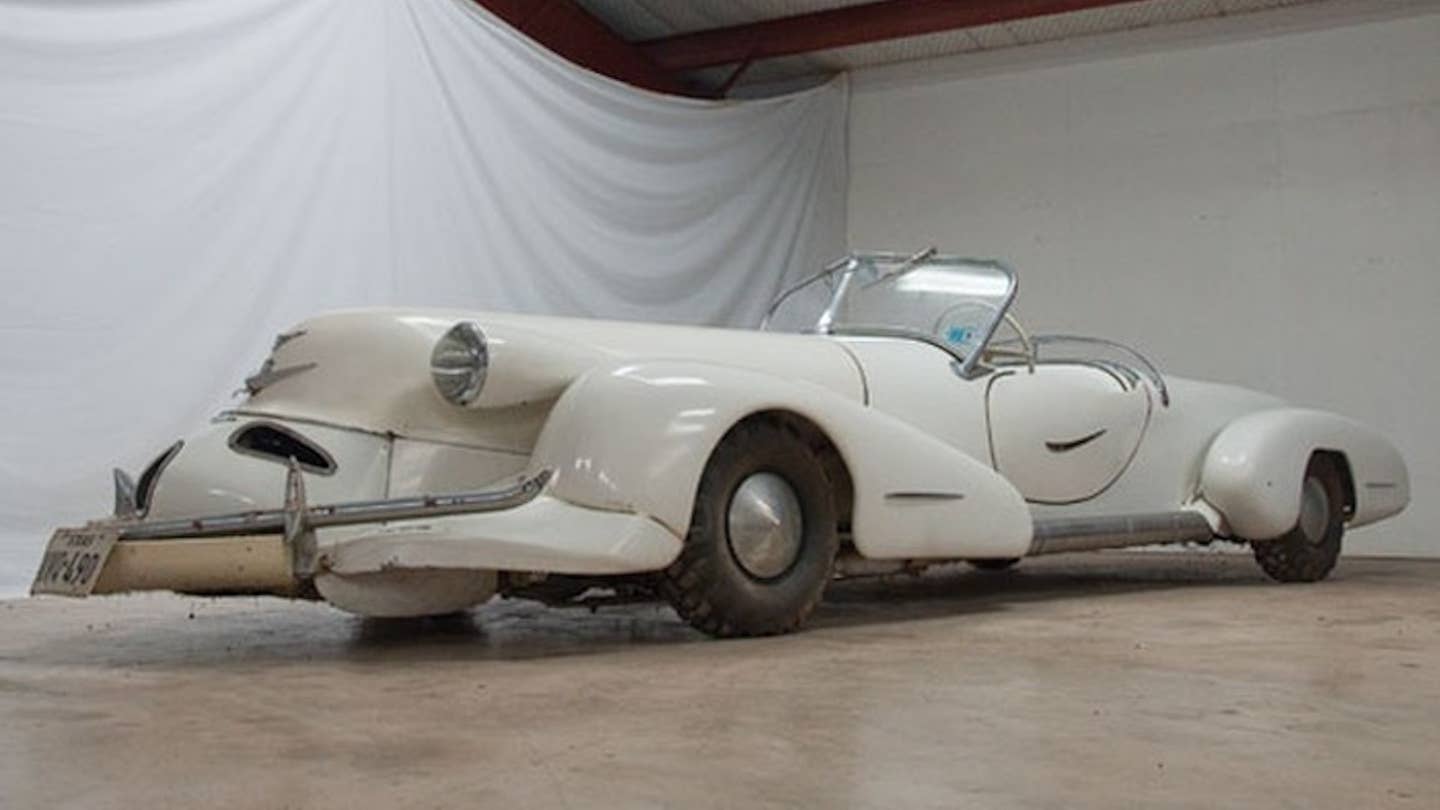 A long, low white roadster with aerodynamic 1930s bodywork