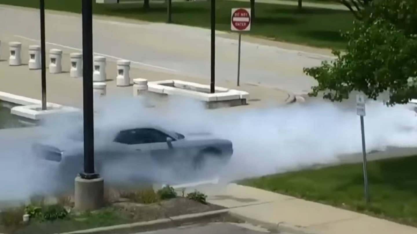 gray car in a cloud of burnout smoke