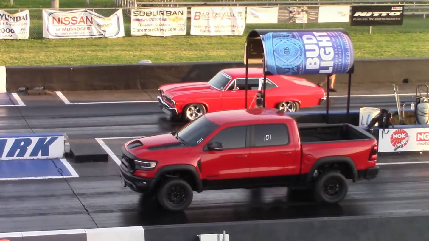 red truck and red muscle car on a drag strip