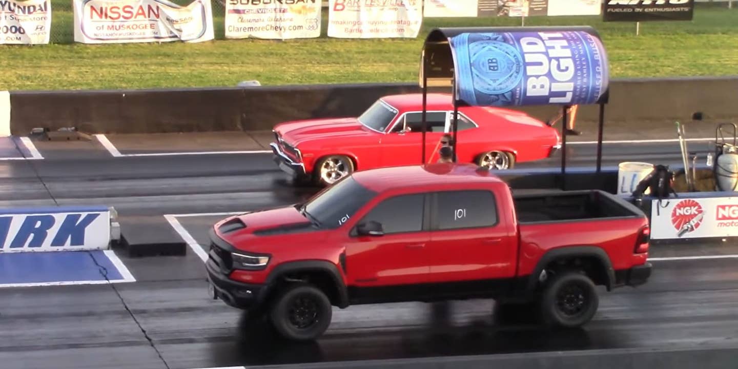 red truck and red muscle car on a drag strip