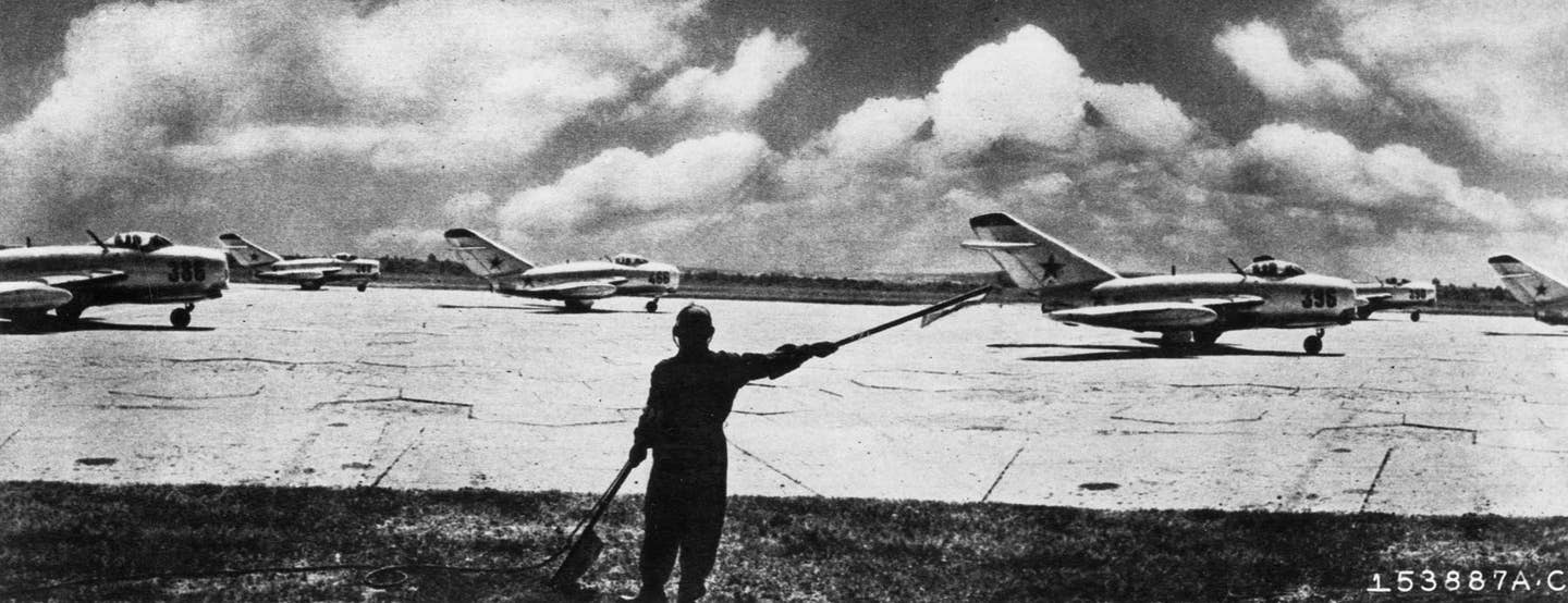 A flight of Soviet MiG-15s prepares for takeoff in a typical 1950s-era propaganda image. <em>U.S. Air Force</em>