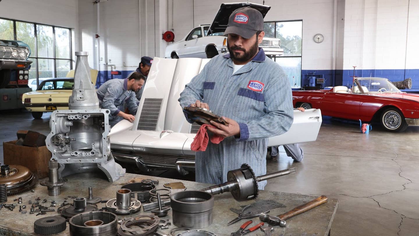 A technician poses at an AAMCO facility