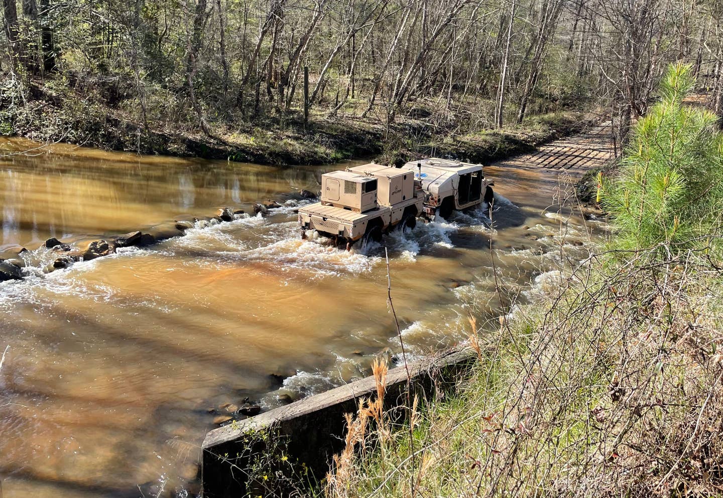 A Plasan ATeMM trailer makes a water-crossing, towed here by a Humvee. <em>Plasan</em>