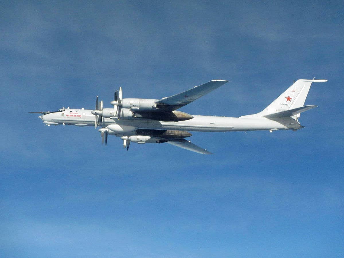 A Russian Navy Tu-142 Bear-F maritime reconnaissance and anti-submarine warfare aircraft, one of the types that can be used to track the movements of Royal Navy and other submarines. This example was intercepted by Royal Air Force Typhoon fighter jets flying from their base in Scotland. <em>Crown Copyright</em>