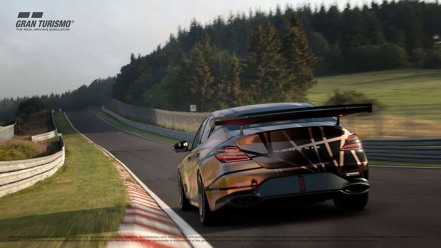 In a Gran Turismo 7 screenshot, a Genesis G70 race car is speeding around a straight section of the Nurburgring.