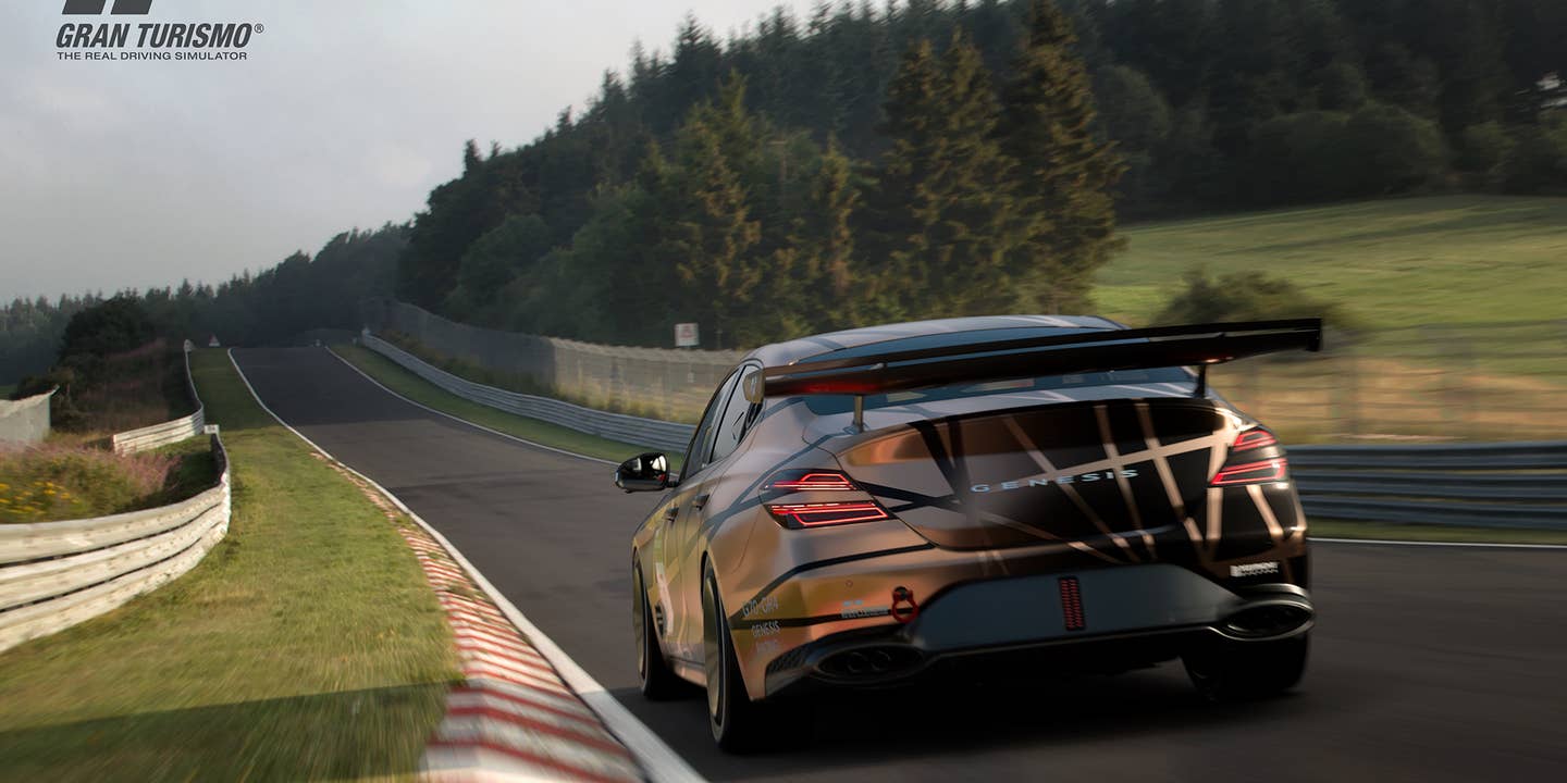In a Gran Turismo 7 screenshot, a Genesis G70 race car is speeding around a straight section of the Nurburgring.
