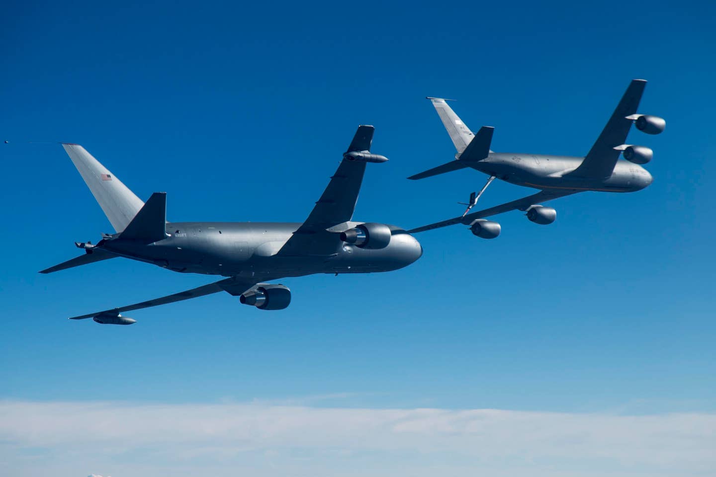 A KC-46A, left, conducting tests of aircraft acceleration and vibration exposure while flying in receiver formation behind a KC-135 Stratotanker. <em>U.S. Air Force photo/Christopher Okula</em>