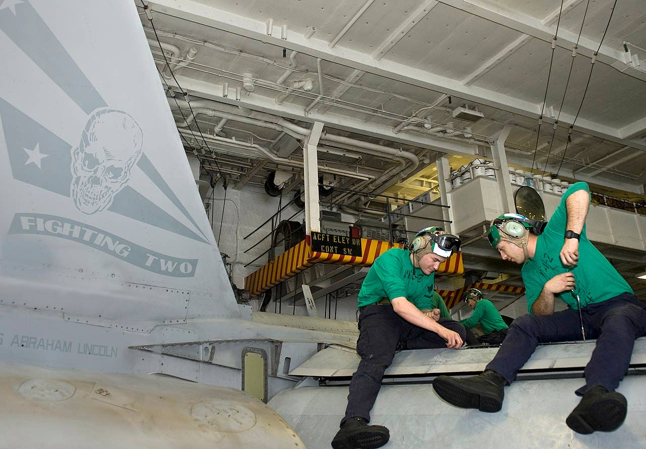 Sailors work on a F/A-18 Super Hornet belonging to the VFA-2, the Bounty Hunters. (U.S. Navy photo by Mass Communication Specialist 2nd Class Jonathan P. Idle/Released)