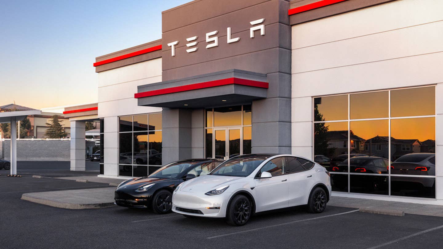 Tesla service center with two vehicles parked outside