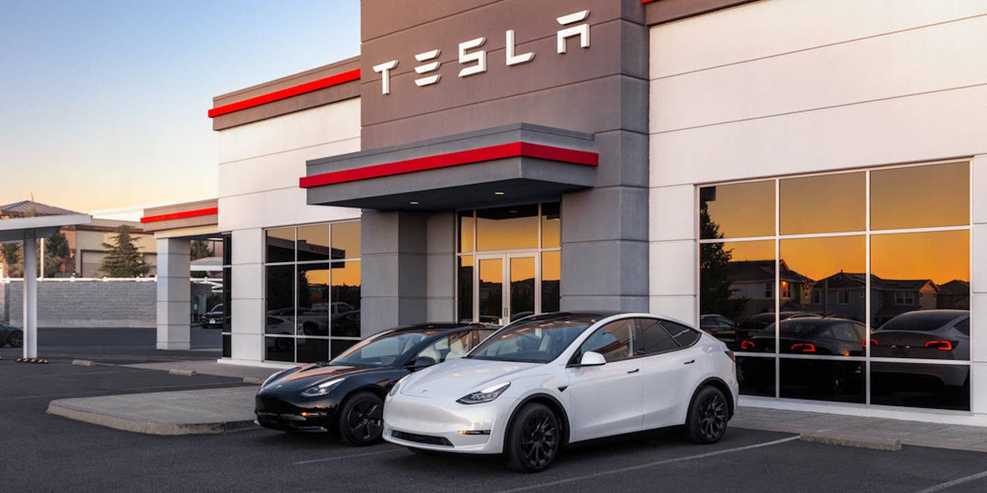 Tesla service center with two vehicles parked outside