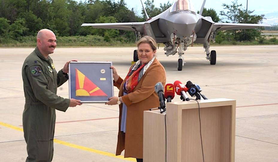 North Macedonia's Minister of Defense Slavjanka Petrovska, at right, presents a framed example of her country's national flag, to Vermont Air National Guard Lt. Col. John Macrae during a press conference at Petrovec Military Airport on June 17, 2022. <em>North Macedonia MoD</em>