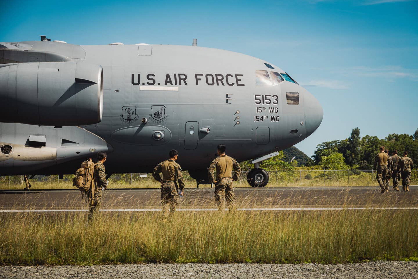 U.S. Marines prepare to unload gear off of a C-17 transport plane, in support of Valiant Shield 22 on Palau, on June 10, 2022. <em>U.S. Marine Corps photo by Cpl. Samuel Fletcher</em>