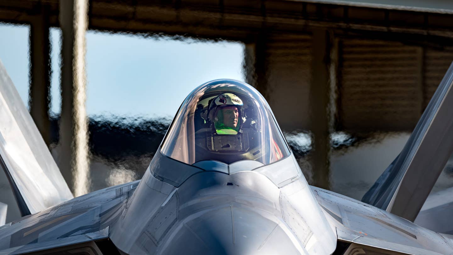A U.K. Royal Air Force exchange officer in the cockpit of an F-22 of the 94th Fighter Squadron at Joint Base Langley-Eustis. <em>U.S. Air Force photo by Staff Sgt. Ericha Fitzgerald</em>