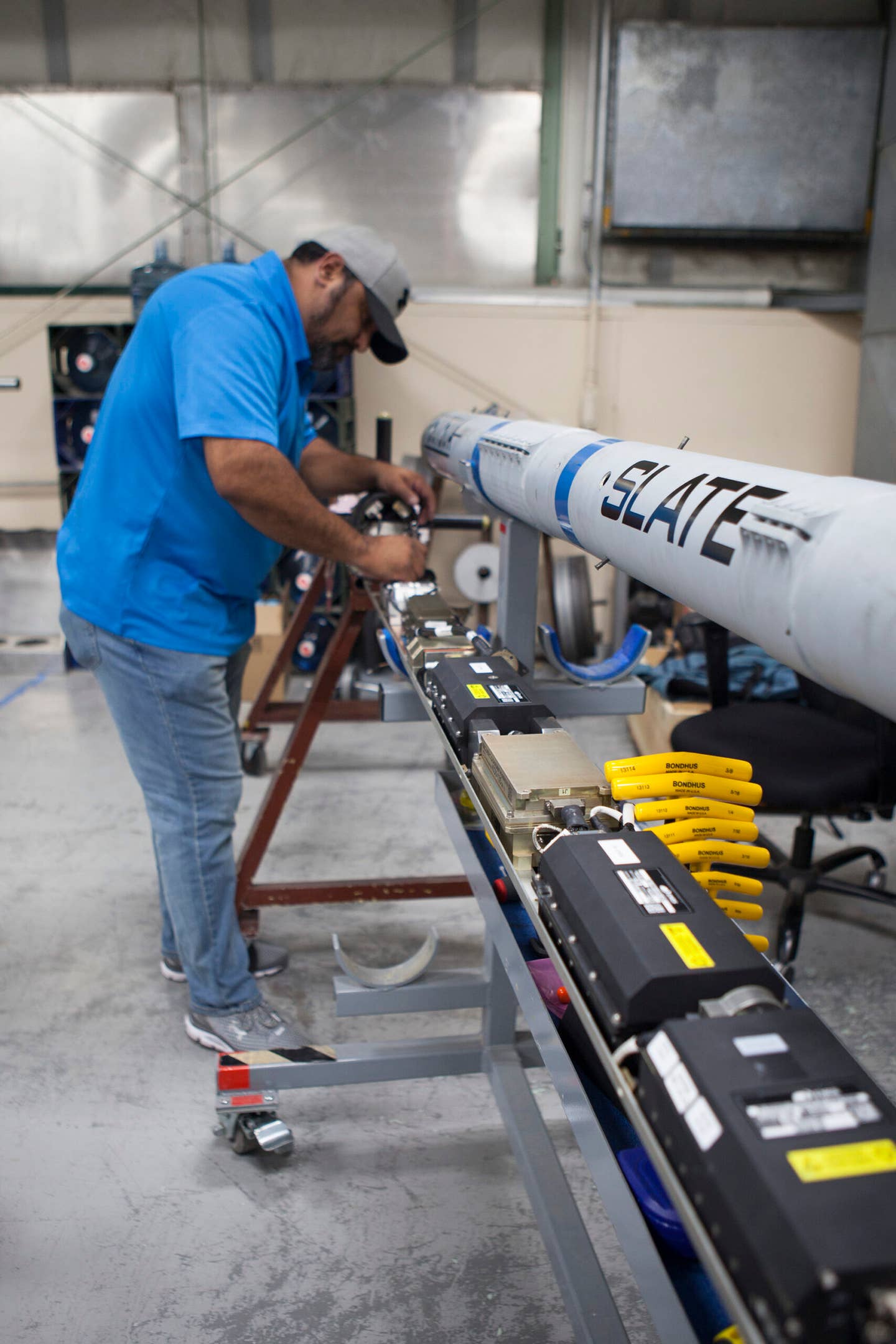 Raul Mendoza, with the Cubic Corporation, works on the SLATE LVC pod during a demonstration at Nellis Air Force Base, Nevada. <em>U.S. Air Force photo / William Graver</em>