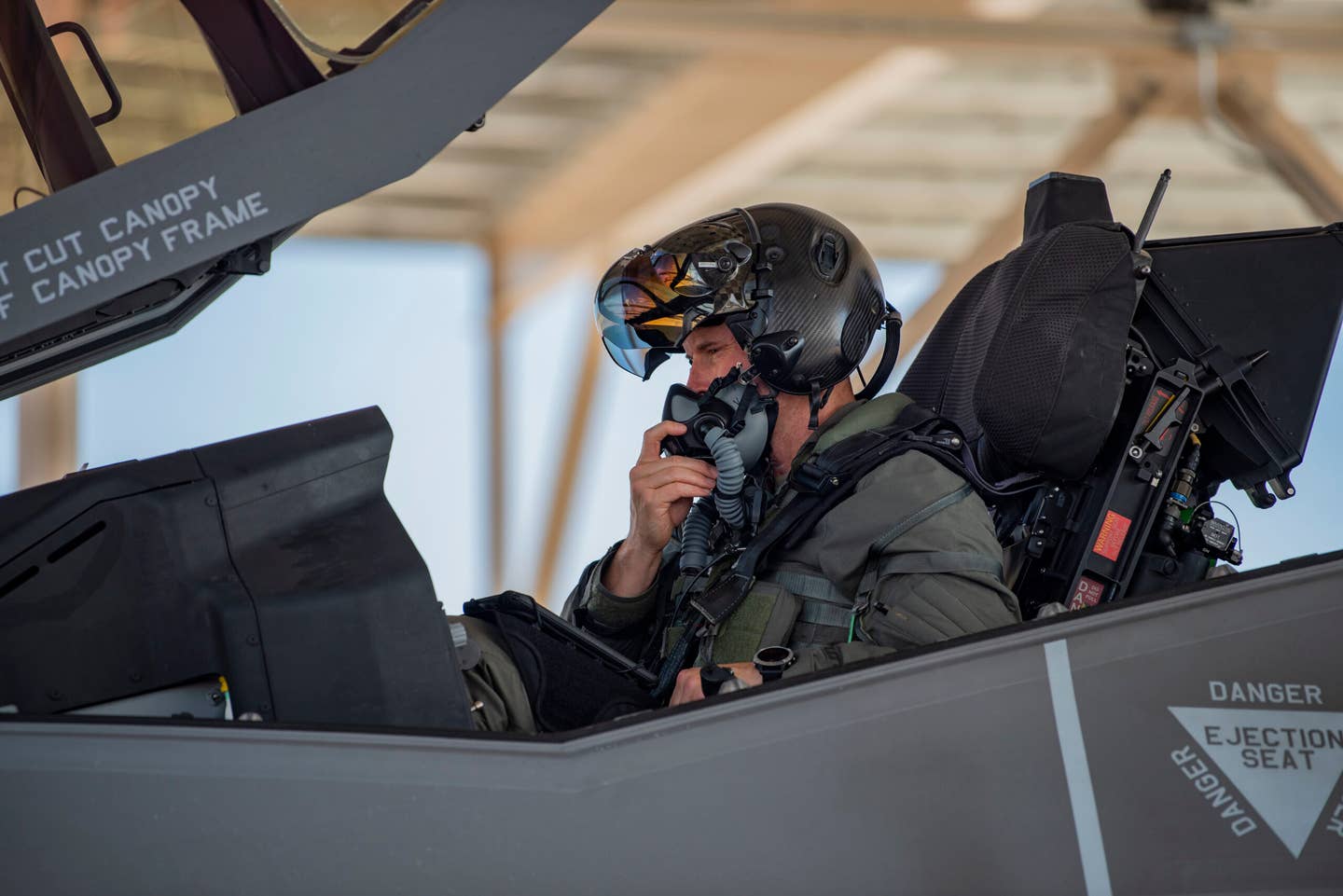 Col. Scott Mills, a 64th Aggressor Squadron F-35A pilot, performs preflight checks before launching to participate in Red Flag 21-3 at Nellis Air Force Base, Nevada in August 2021. This was the first Red Flag exercise in which blue air participants went go head-to-head with F-35 aggressor pilots. <em>U.S. Air Force photo by Airman 1st Class Zachary Rufus</em>