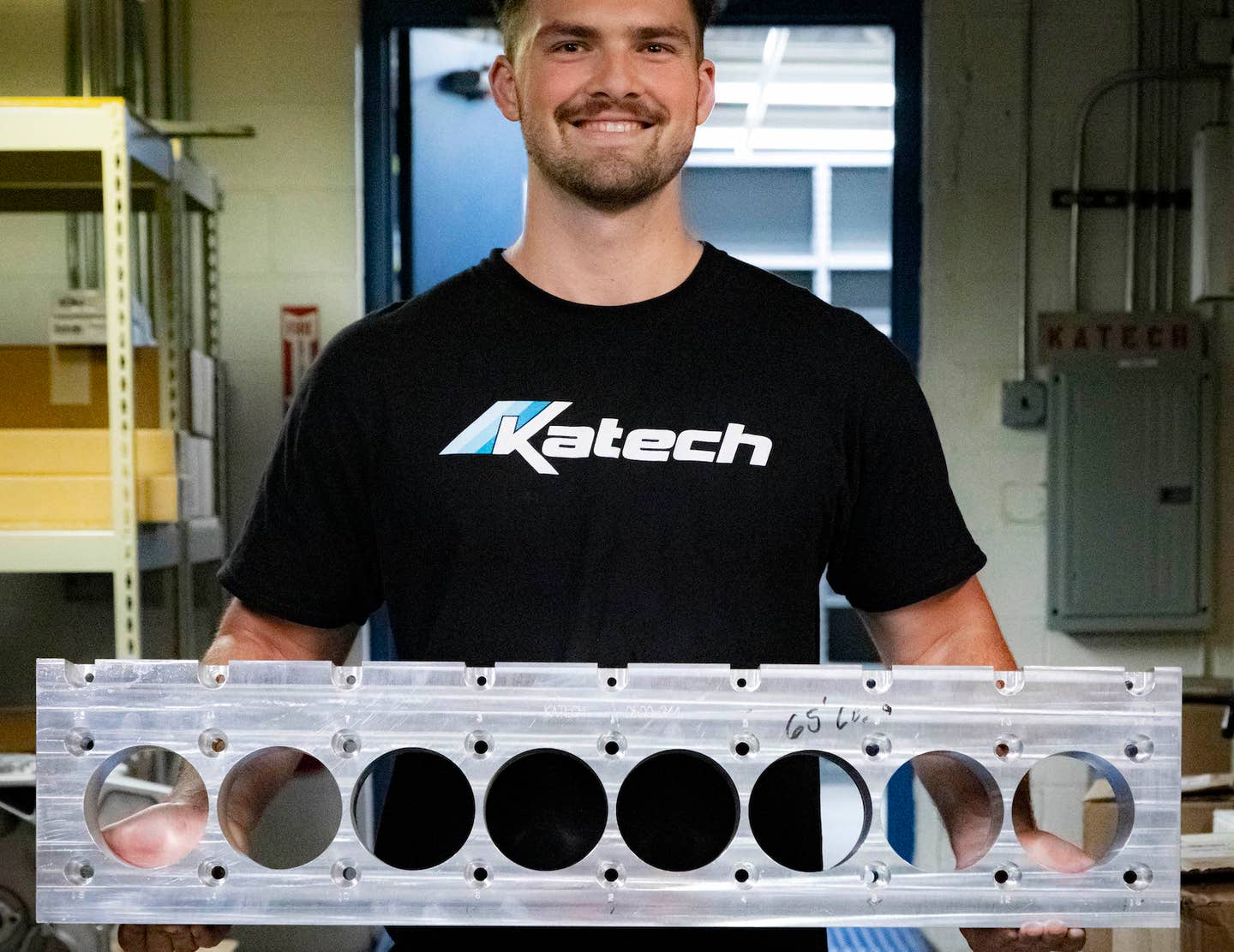 A Katech employee holds an original GM XV16 deck plate | Katech
