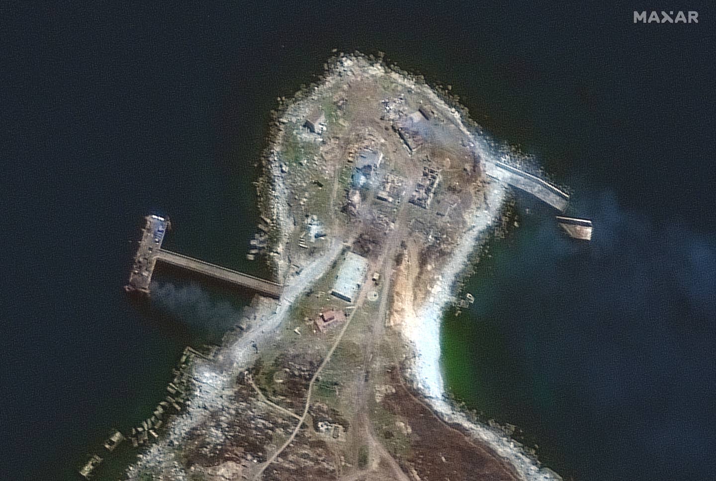 A closer view of the northern end of Snake Island on June 30 showing the burning pier and buildings. <em>Maxar</em>