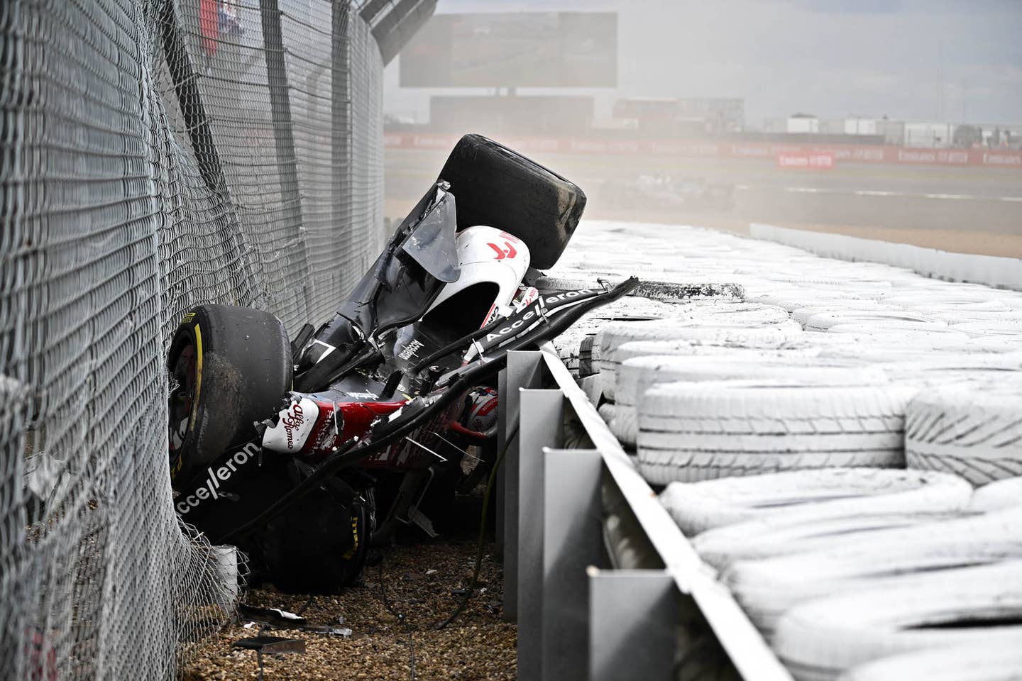 TOPSHOT - Alfa Romeo Chinese driver Zhou Guanyu is seen in the crash barriers during an incident at the star during the Formula One British Grand Prix at the Silverstone motor racing circuit in Silverstone, central England on July 3, 2022. (Photo by Ben Stansall / AFP) (Photo by BEN STANSALL/AFP via Getty Images)