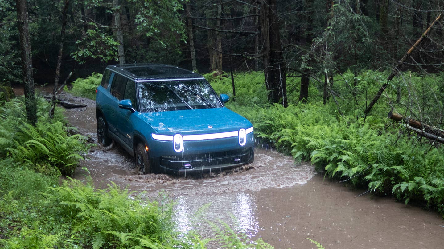 Rivian R1S fording water.