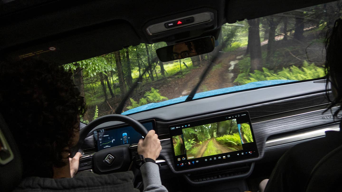 Rivian R1S interior during off-road driving.