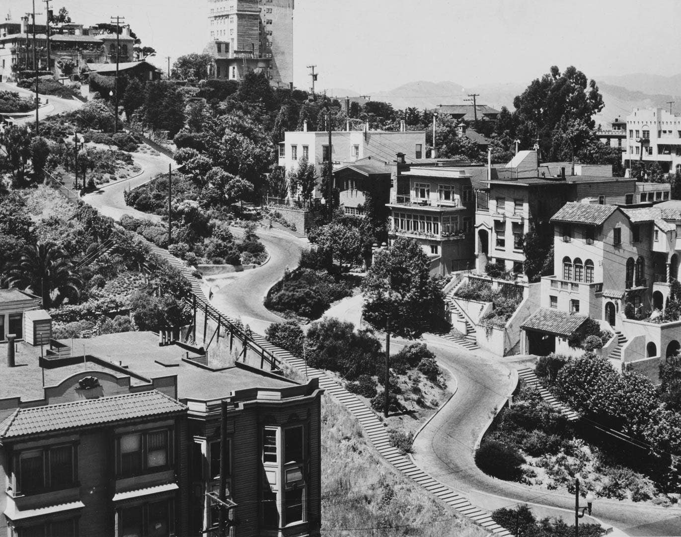 Properties along Lombard Street, labeled 'the crookedest street in the world,' a steep, one-block section with eight hairpin bends, running east to west in the Russian Hill neighborhood of San Francisco circa 1945. (Photo by UPI/Bettmann Archive via Getty Images)