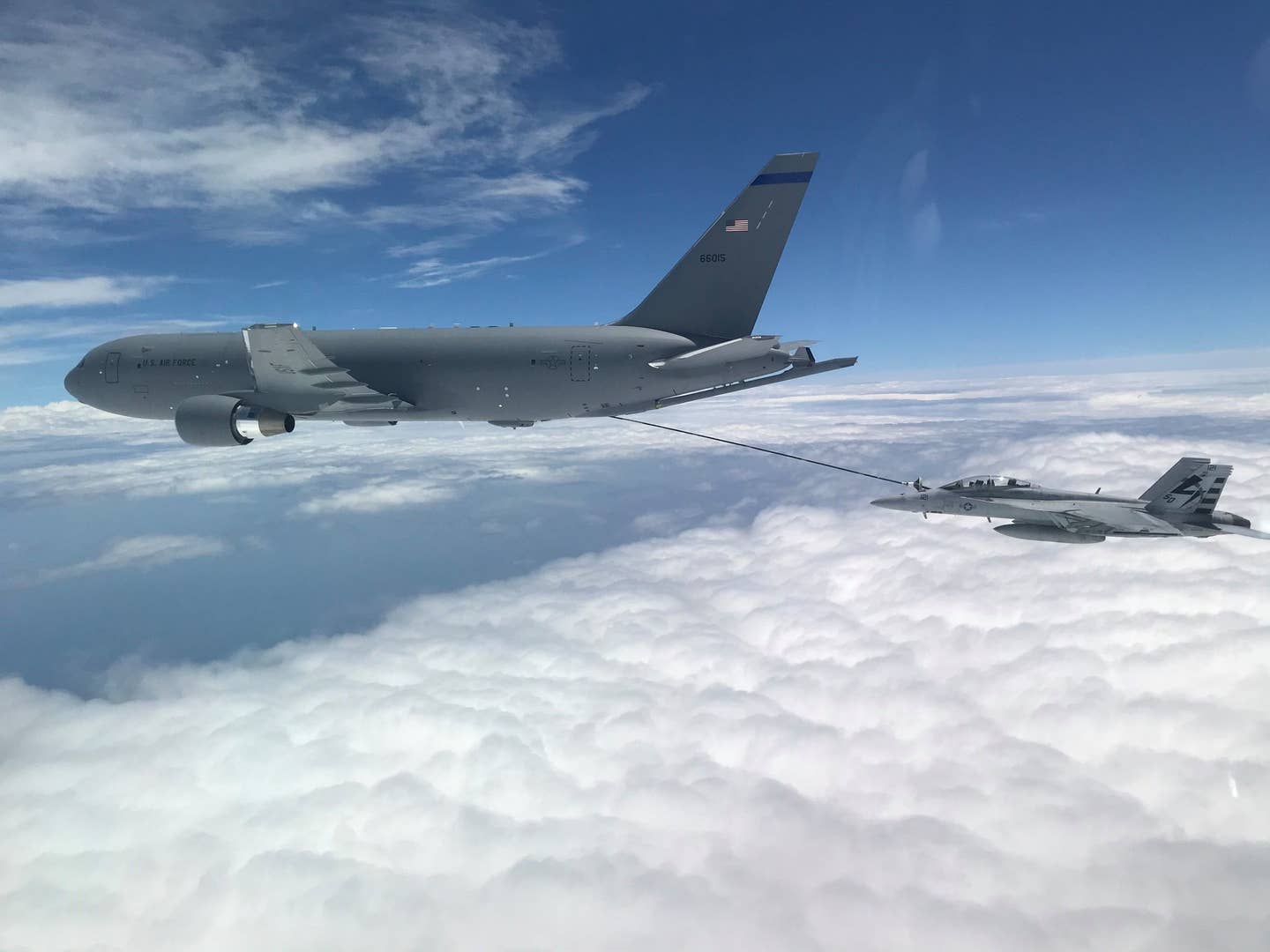 A KC-46A refuels a U.S. Navy F/A-18F Super Hornet off the coast of Maryland, July 1, 2020. This marked the first time the aircrew utilized the KC-46A centerline drogue system to refuel an aircraft. <em>U.S. Navy photo by Lt. Zach Fisher</em>