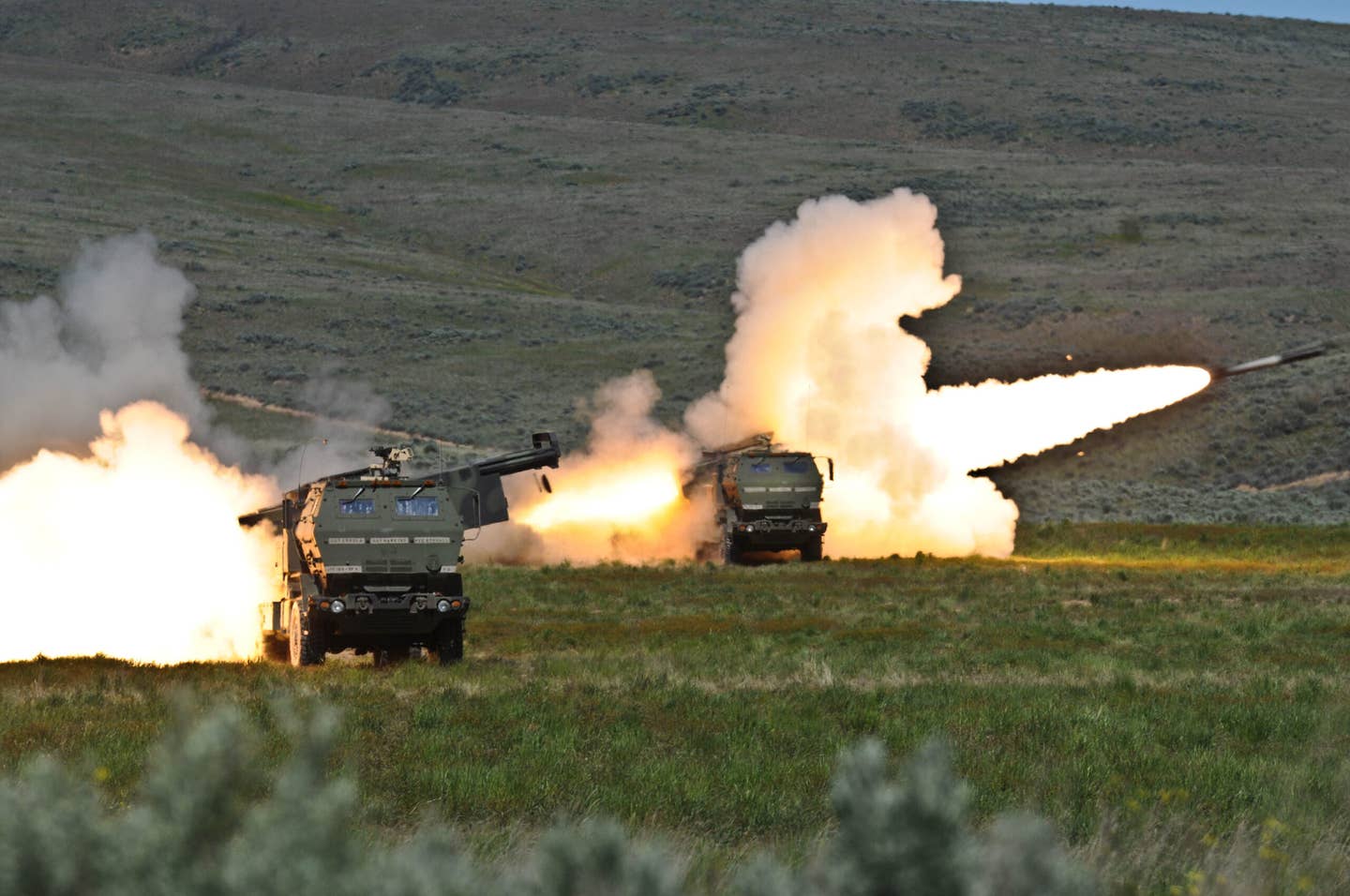 3rd Field Artillery Regiment soldiers fire two rounds from their High Mobility Artillery Rocket systems at Yakima Training Center. <em>Wikimedia Commons</em>