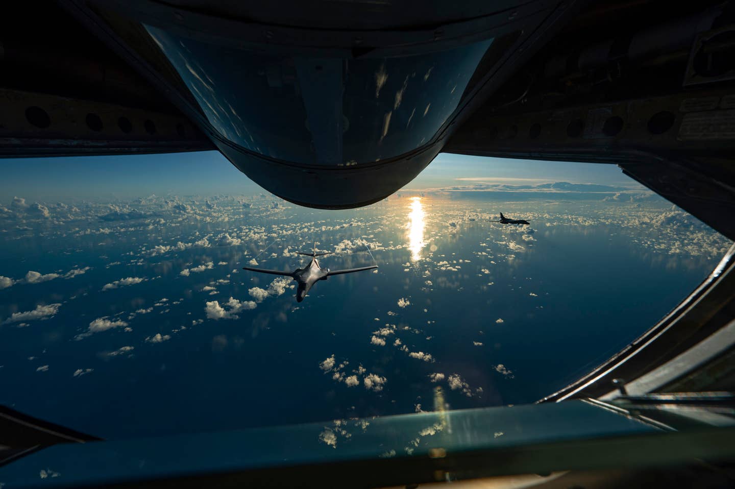 Two B-1Bs in formation behind a KC-135 Stratotanker, assigned to 506th Expeditionary Air Refueling Squadron, over the Pacific Ocean, June 20, 2022. <em>U.S. Air Force photo by Master Sgt. Nicholas Priest</em>