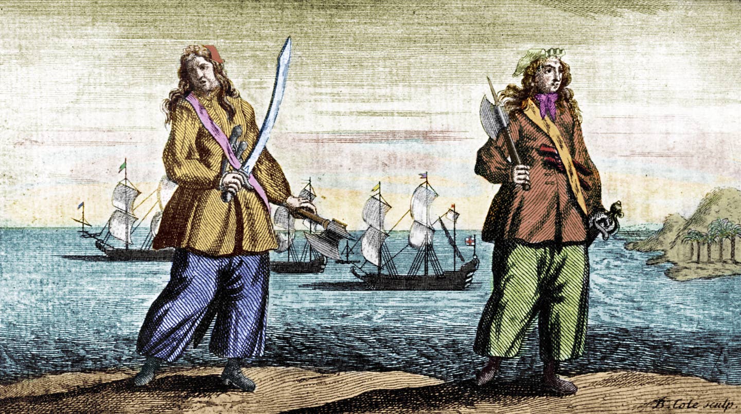 Two of the best-known female pirates, the Irish-American Anne Bonny and the English Mary Read, in a colorized version of an engraving by B. Cole. <em>Culture Club/Getty Images</em>