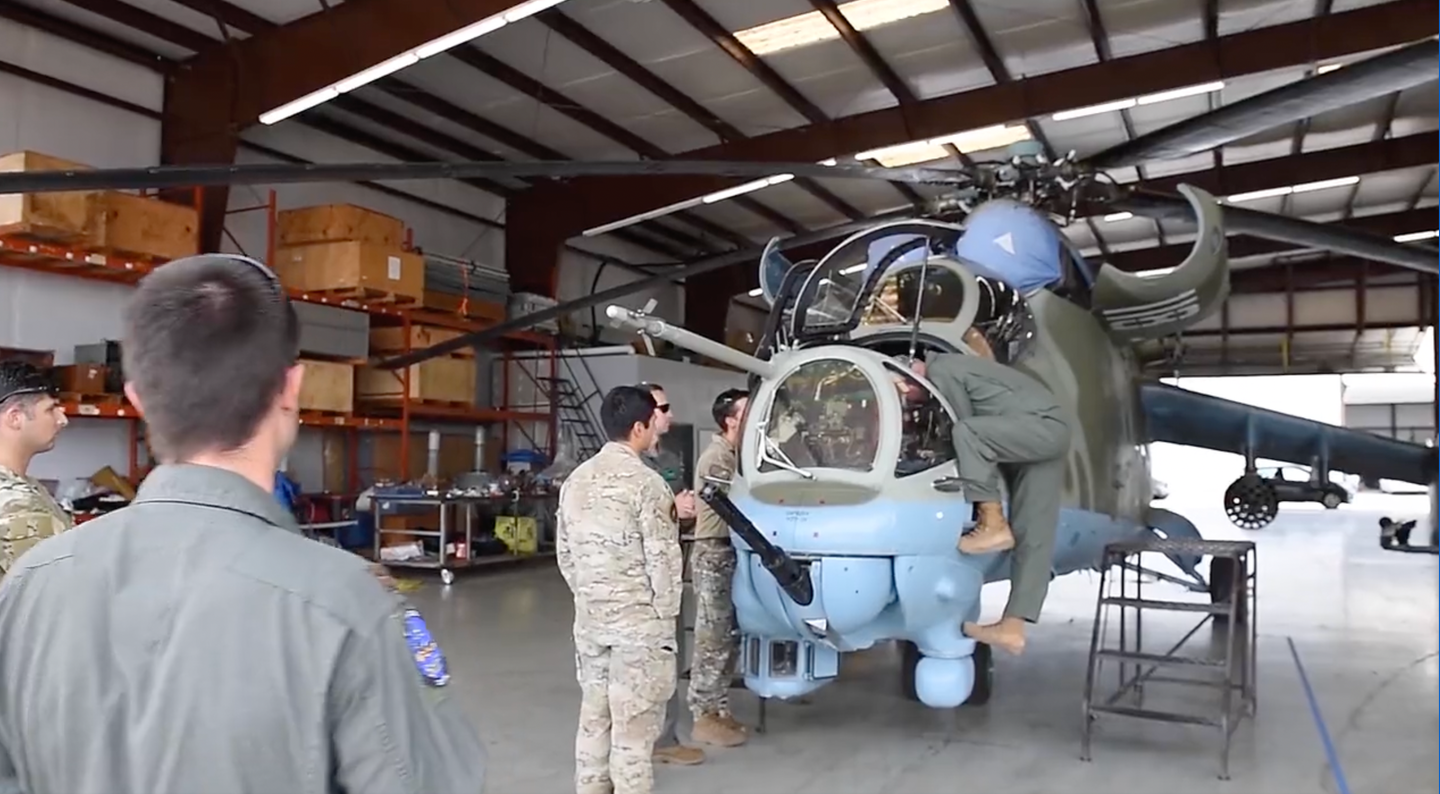 USAF pilots inspect the Mil Mi-24 "118" before the training exercise. <em>Department of Defense.</em>