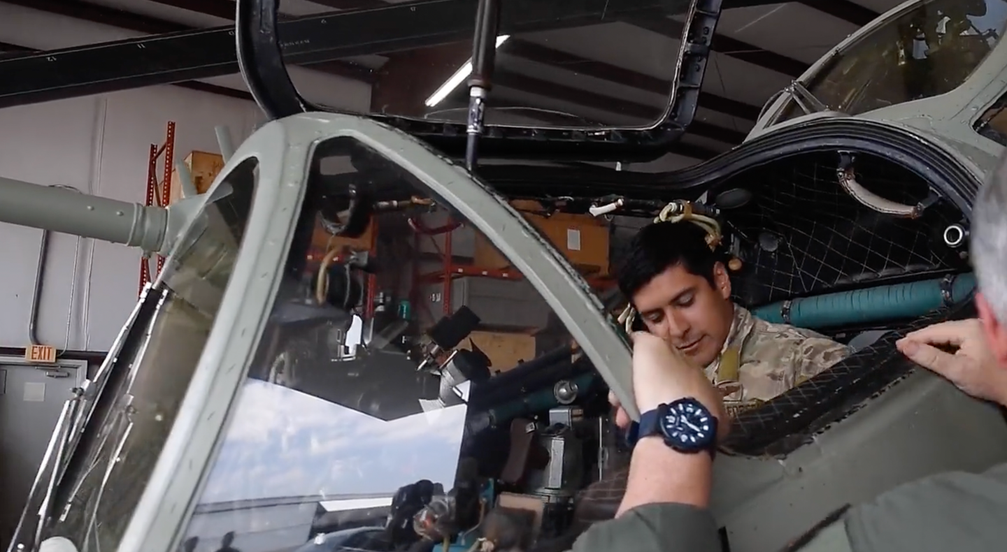 Captain Tyler Hudson climbs into the Mi-24's cockpit. <em>Department of Defense.</em>