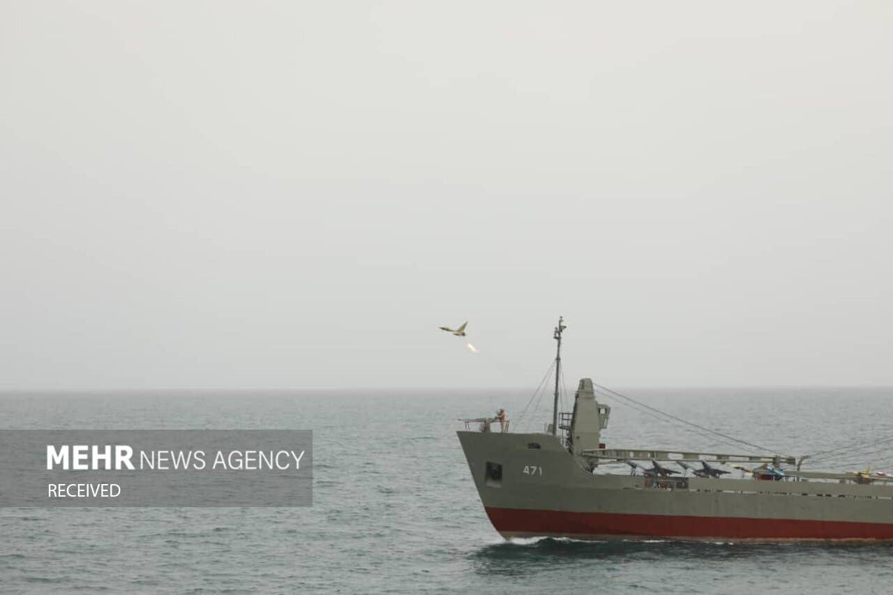 One of the Iranian drones used in the unveiling ceremony of the Iranian Navy's "drone-carrier" division flying above auxiliary ship <em>Delvar. MEHR News Agency</em>