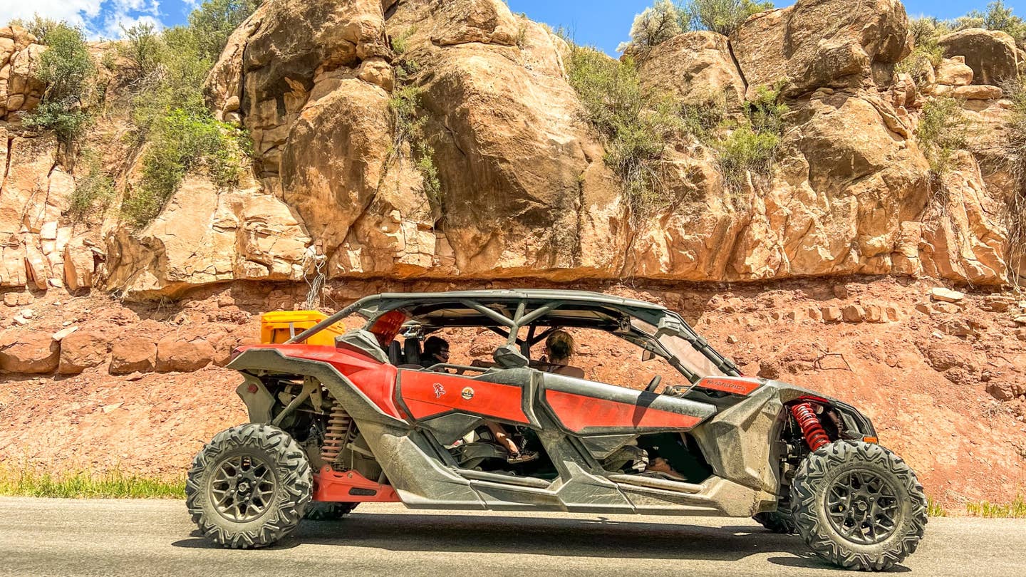 A Can-Am Maverick X3 Max DS Turbo R sitting in front of a rock formation.