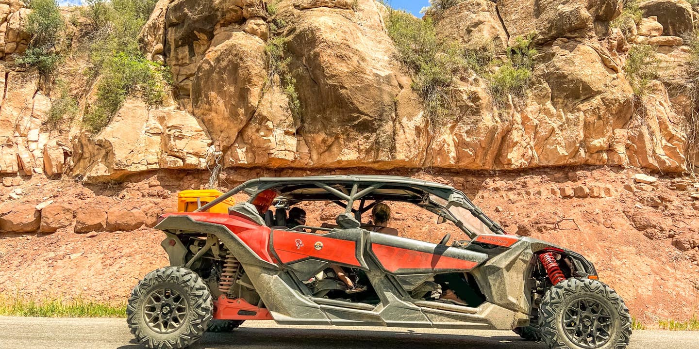 A Can-Am Maverick X3 Max DS Turbo R sitting in front of a rock formation.