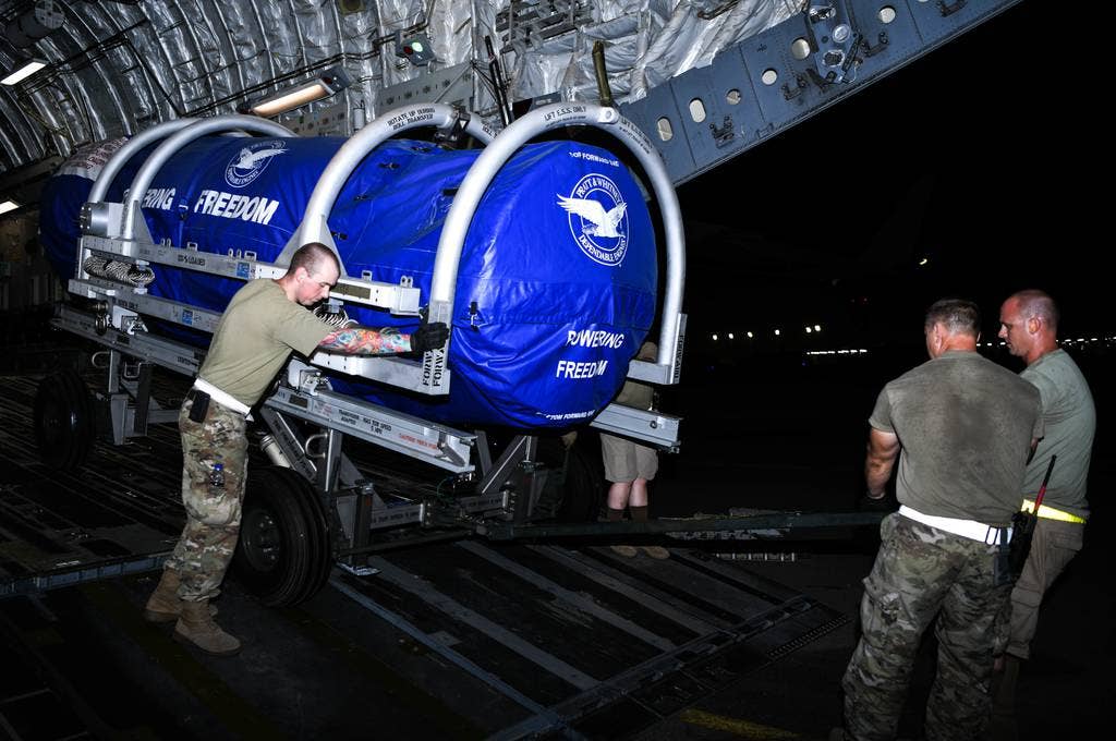 Members of the 380th Expeditionary Logistics Readiness Squadron Air Terminal Operations Center wheel an F-35A Lightning II engine out of a C-17 Globemaster III aircraft, August 26, 2020, at Al Dhafra Air Base, United Arab Emirates. (Tech. Sgt. Charles Taylor/U.S. Air Force)