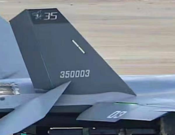 A close-up of the prototype J-35's tail, with what appears to be a 'flying shark' logo at the top of the right tail fin. <em>Chinese internet</em>