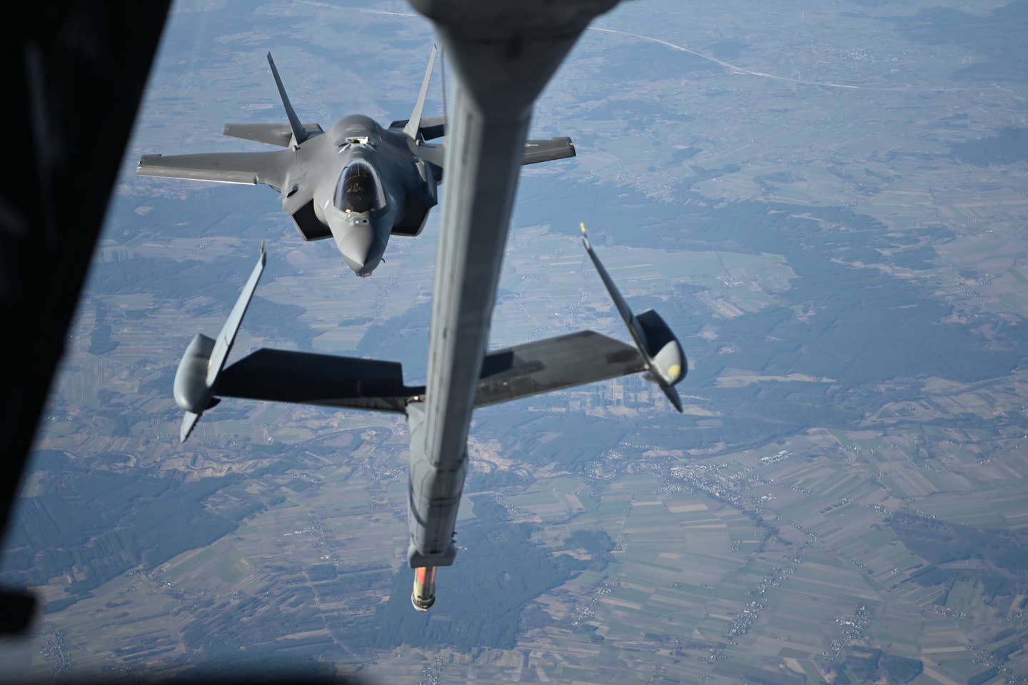A U.S. Air Force F-35 assigned to the 34th Fighter Squadron approaches a KC-10 Extender to receive fuel over Poland, February 24, 2022. The F-35, originally from Hill Air Force Base, Utah, was forward deployed to NATO’s eastern flank to support NATO’s Enhanced Air Policing mission. <em>U.S. Air Force photo by Senior Airman Joseph Barron</em>