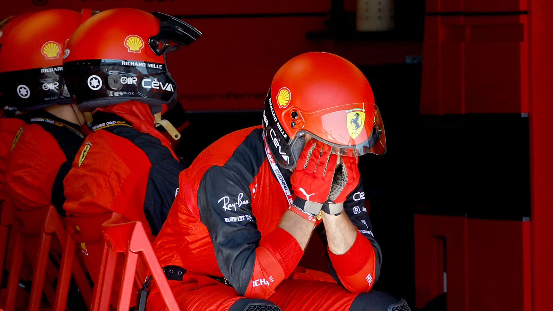 A Ferrari mechanic with their head in their hands