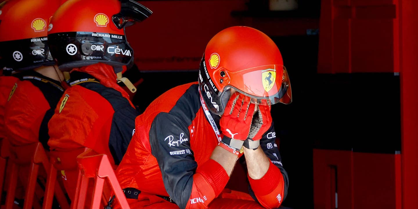 A Ferrari mechanic with their head in their hands