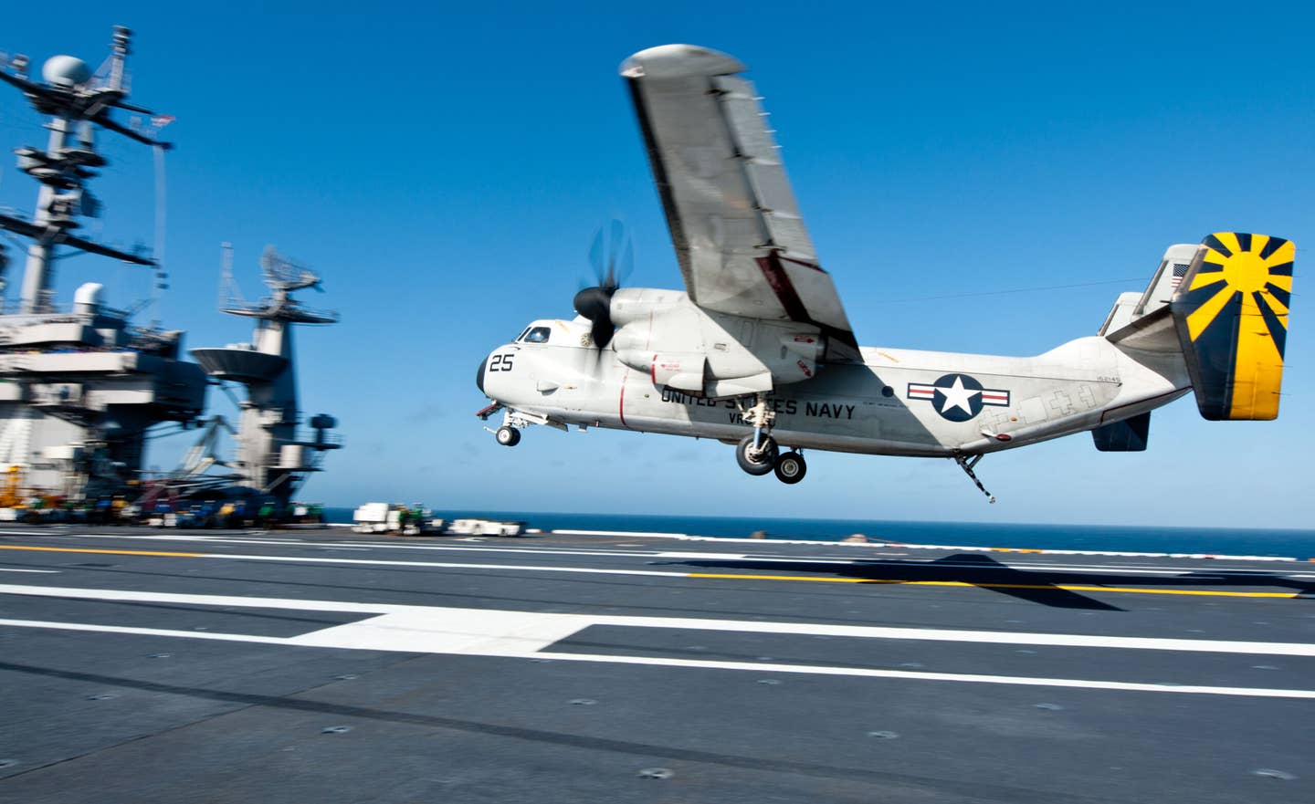 A C-2A Greyhound assigned to the Providers of Fleet Logistics Combat Squadron (VRC) 30 lands on the flight deck of the <em>Nimitz</em>-class aircraft carrier USS <em>John C. Stennis</em>. <em>Credit: Mass Communication Specialist Seaman Nolan Kahn/U.S. Navy</em>