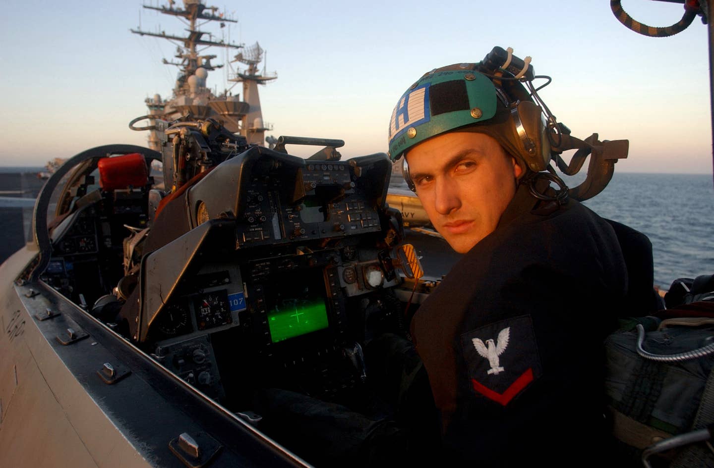 A Photographer’s Mate 3rd Class, assigned to Fighter Squadron 32 (VF-32), runs a system check in the RIO’s rear cockpit of an F-14B Tomcat aboard the aircraft carrier USS <em>Harry S. Truman</em> (CVN-75) in 2005. <em>U.S. Navy photo by Photographer’s Mate Airman Ricardo J. Reyes</em>