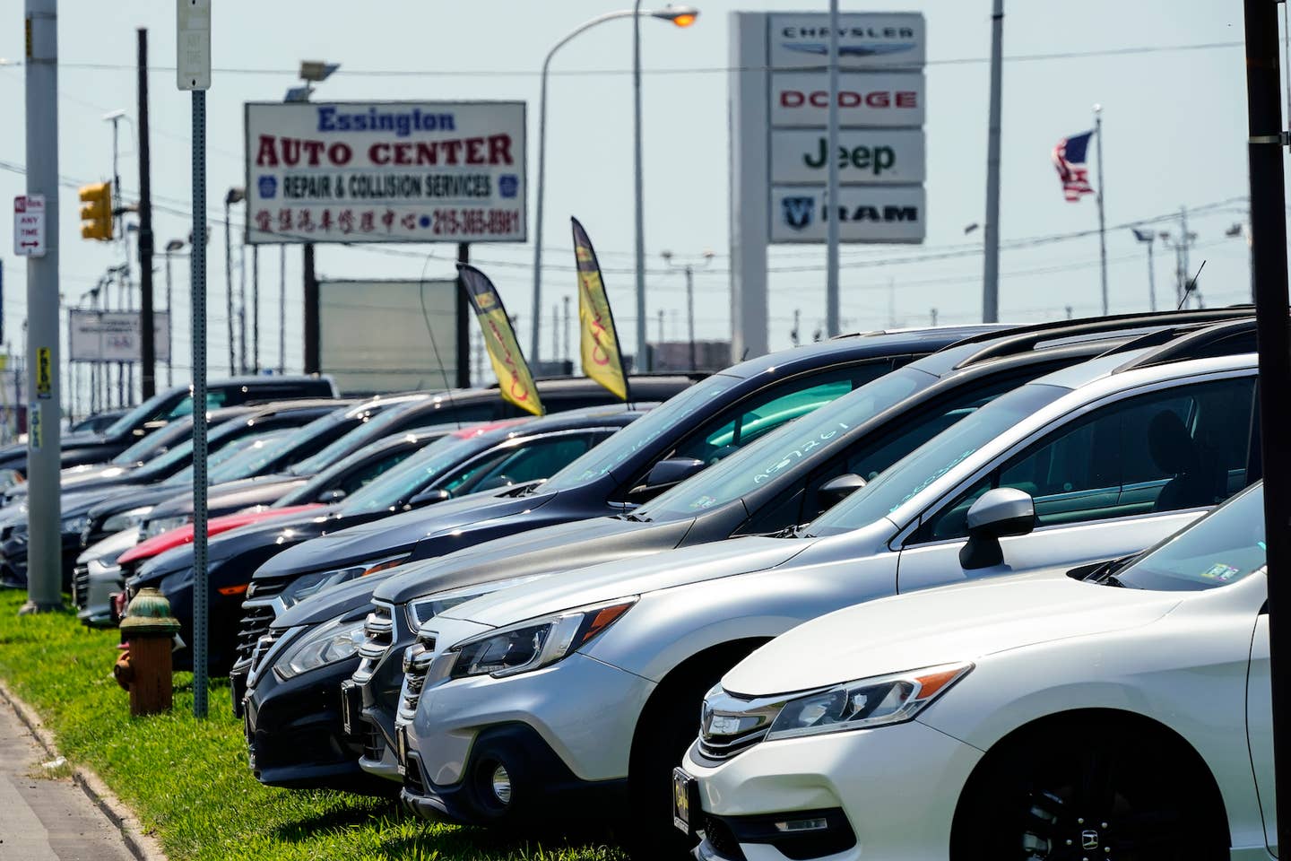 Used cars for sale are parked roadside at an auto lot in Philadelphia | <em>AP Photo, Matt Rourke</em>