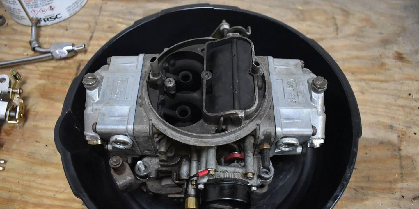 A carburetor in a catch pan.