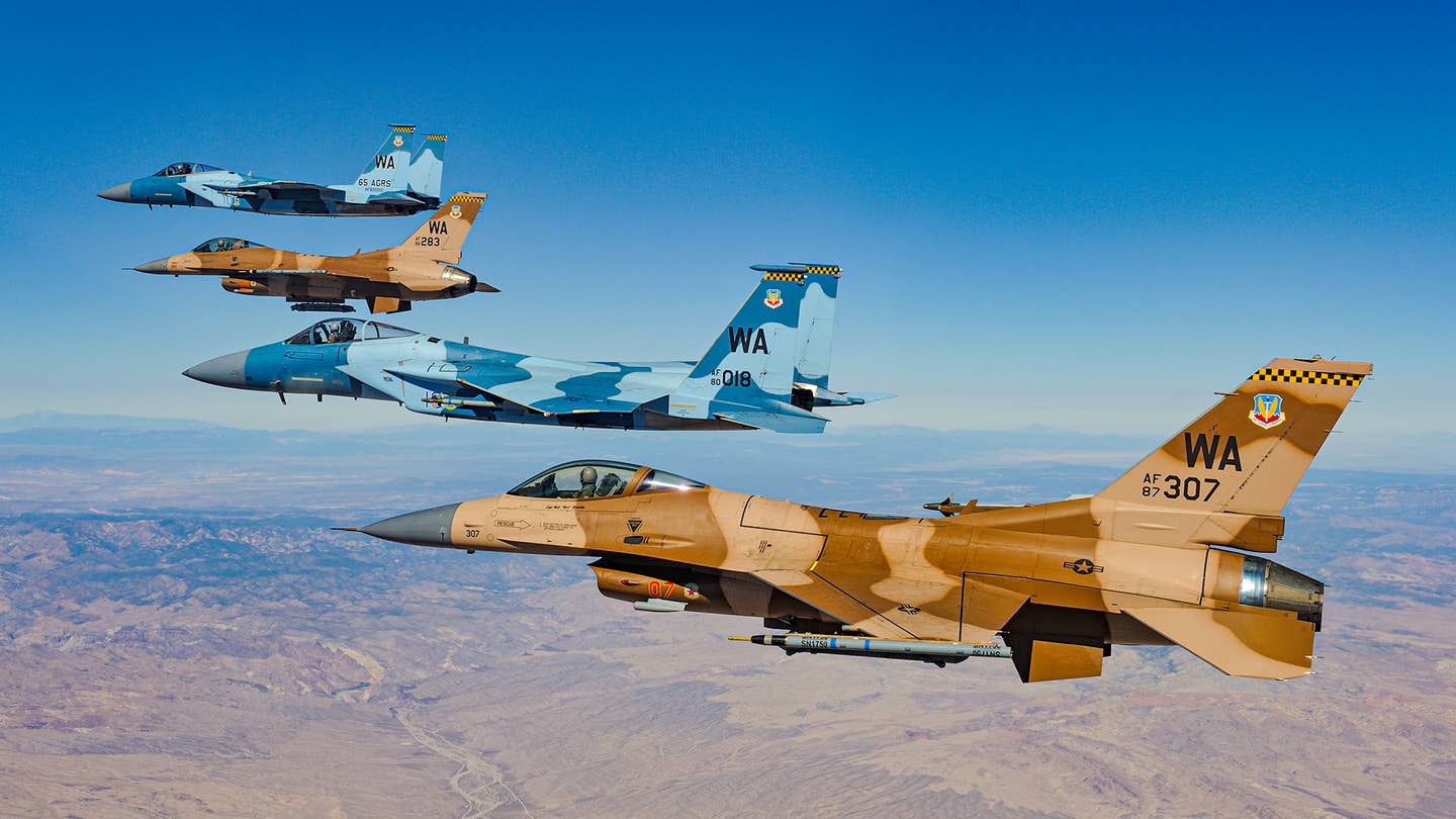 F-15Cs of the 65th AGRS fly with F-16s of the 64th AGRS in 2010. <em>Jamie Hunter</em>