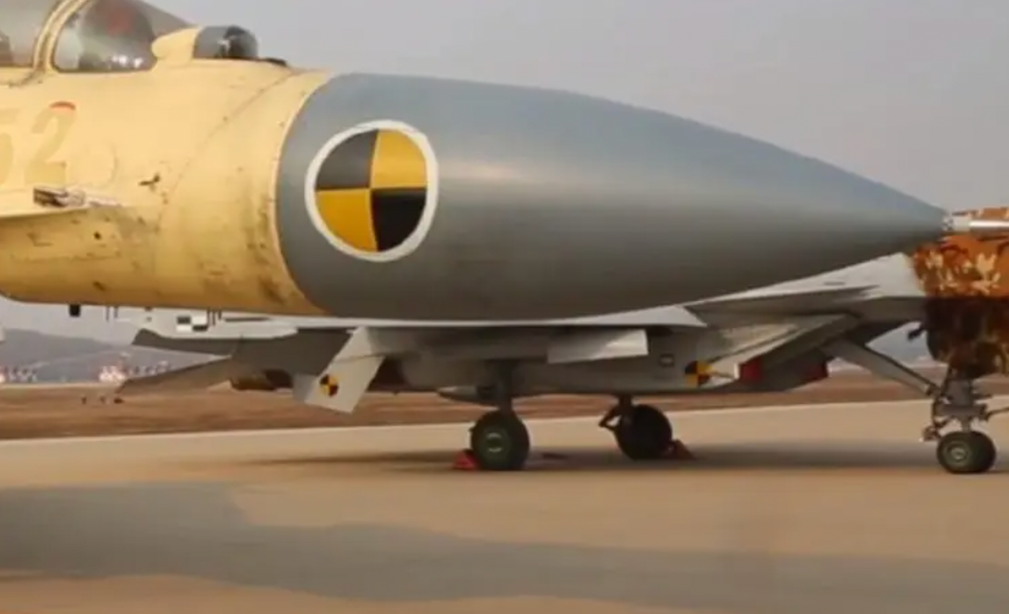 A view of the J-15T (in the background), with its revised nose landing gear featuring a catapult launch bar.&nbsp;<em>Chinese TV screencap</em>