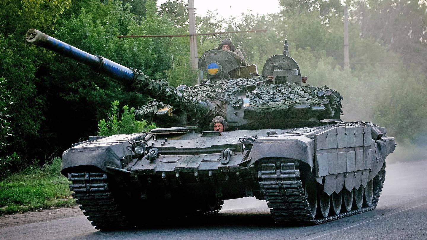 Ukrainian soldiers ride a tank on a road in the Donetsk region on August 13, 2022.