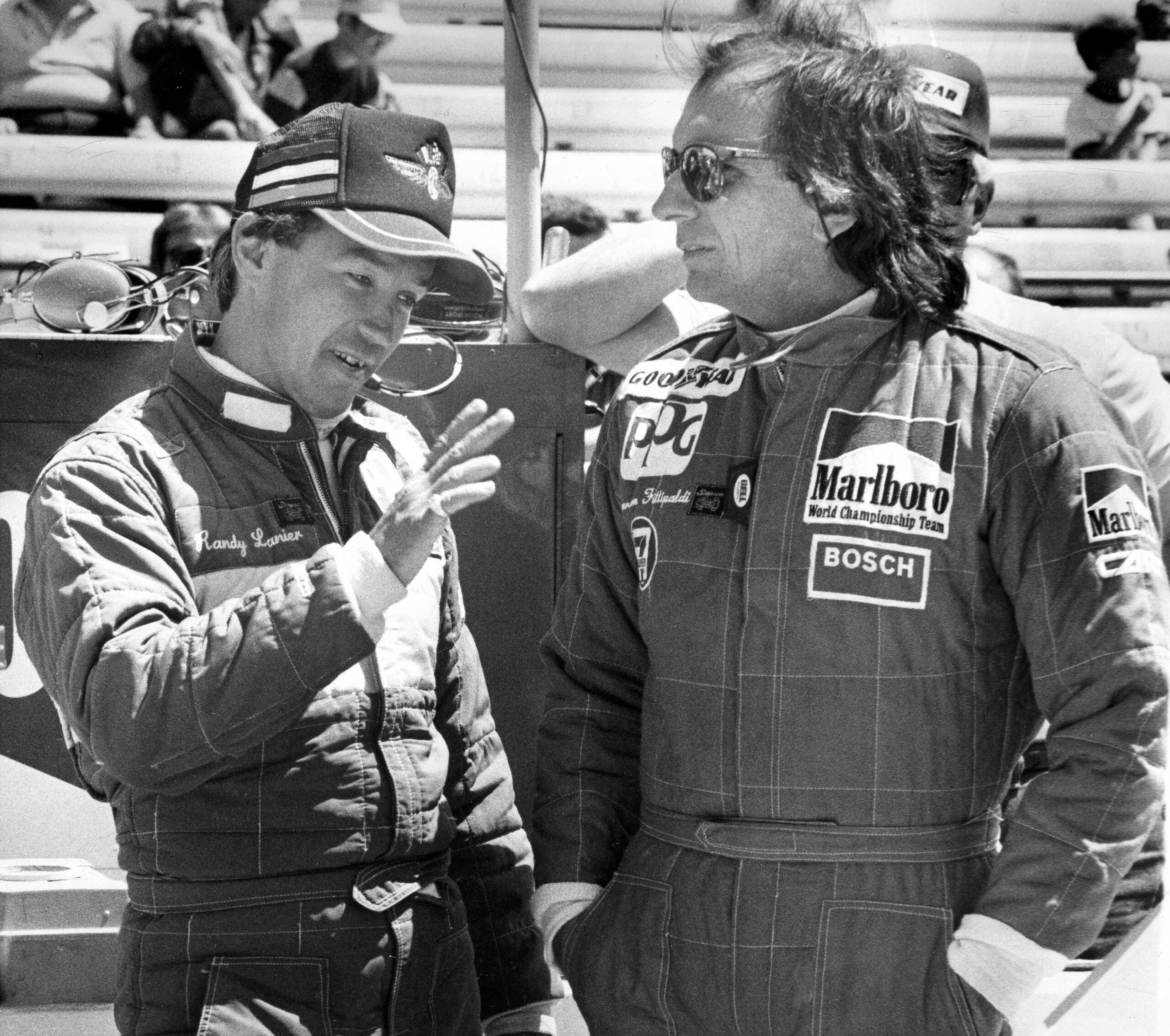 Driver Randy Lanier, left, of Davie, Fla., talks with two-time World Champion Emerson Fittipaldi of Sao Paulo, Brazil, during a break in the action at the Indianapolis Motor Speedway, May 5, 1986. Lanier is attempting to qualify for the Indianapolis 500. (AP Photo/Jerry Mouser)
